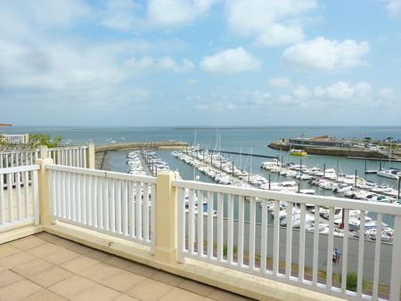 La terrasse de ce bel appartement à vendre à Arcachon offre une superbe vue sur la mer et le port de Plaisance